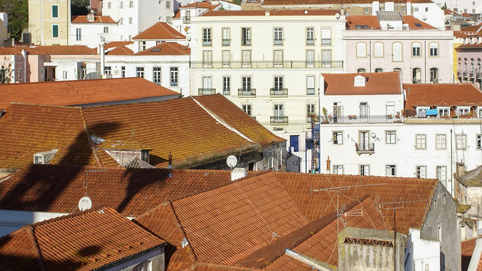 Terracotta rooftops of Lisbon's Alfama district, the historic neighborhood many UK expats explore first