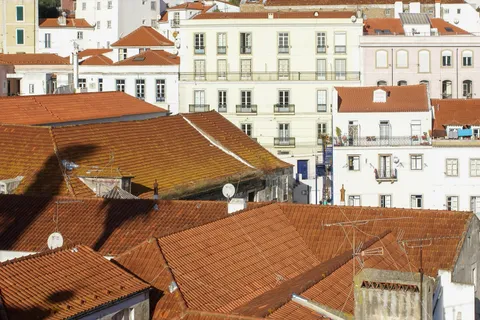 Terracotta rooftops of Lisbon's Alfama district, the historic neighborhood many UK expats explore first