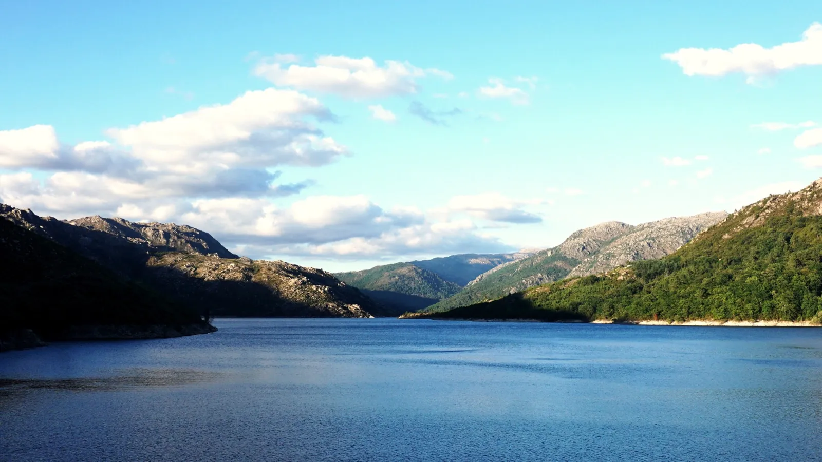 Mountain reservoir surrounded by green peaks in Peneda-Geres National Park, Portugal