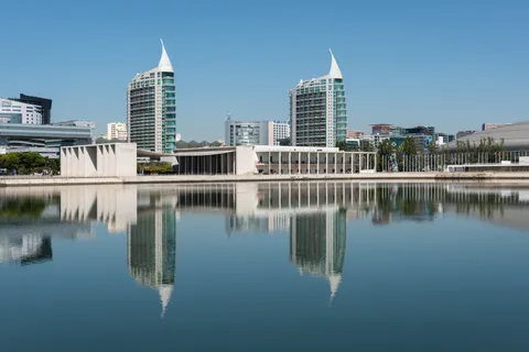 Modern glass towers of Lisbon's Parque das Nacoes business district reflected in water