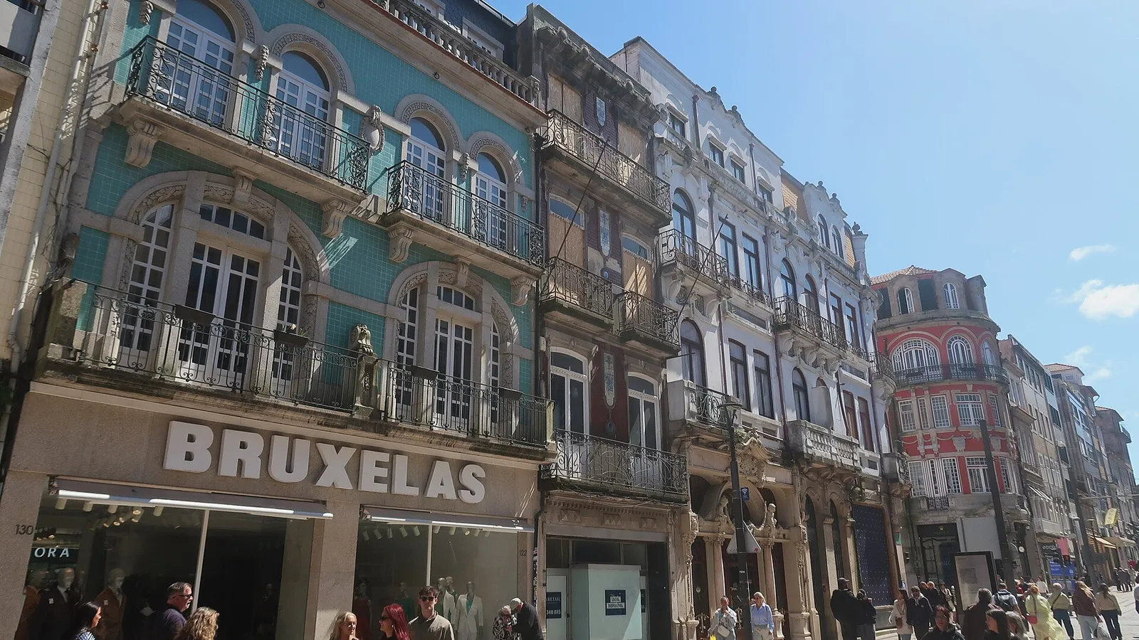 Tiled 19th-century façades along Rua de Santa Catarina in central Porto, with shoppers on the calçada pavement