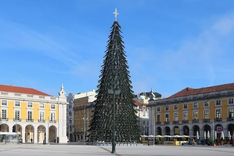 Giant Christmas tree in Praca do Comercio, Lisbon, under a clear blue December sky
