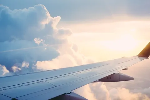Airplane wing at sunset — flying to Portugal for a visa as an American citizen