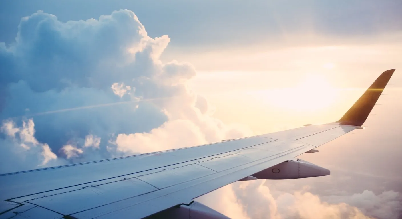 Airplane wing at sunset — flying to Portugal for a visa as an American citizen