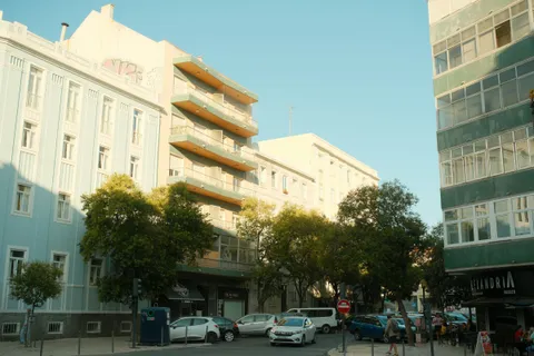 Colorful residential apartment buildings on a Lisbon street, the kind of housing families must prove for reunification