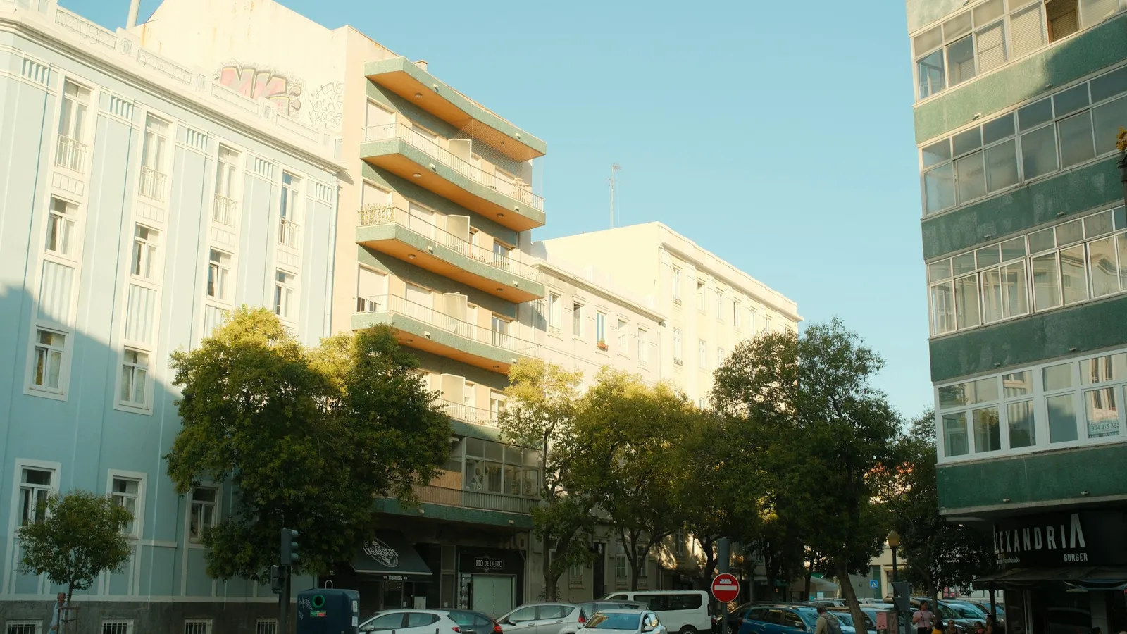 Colorful residential apartment buildings on a Lisbon street, the kind of housing families must prove for reunification