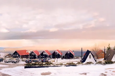 Snow-covered chalets at Penhas da Saude in the Serra da Estrela mountains, Portugal, at sunset