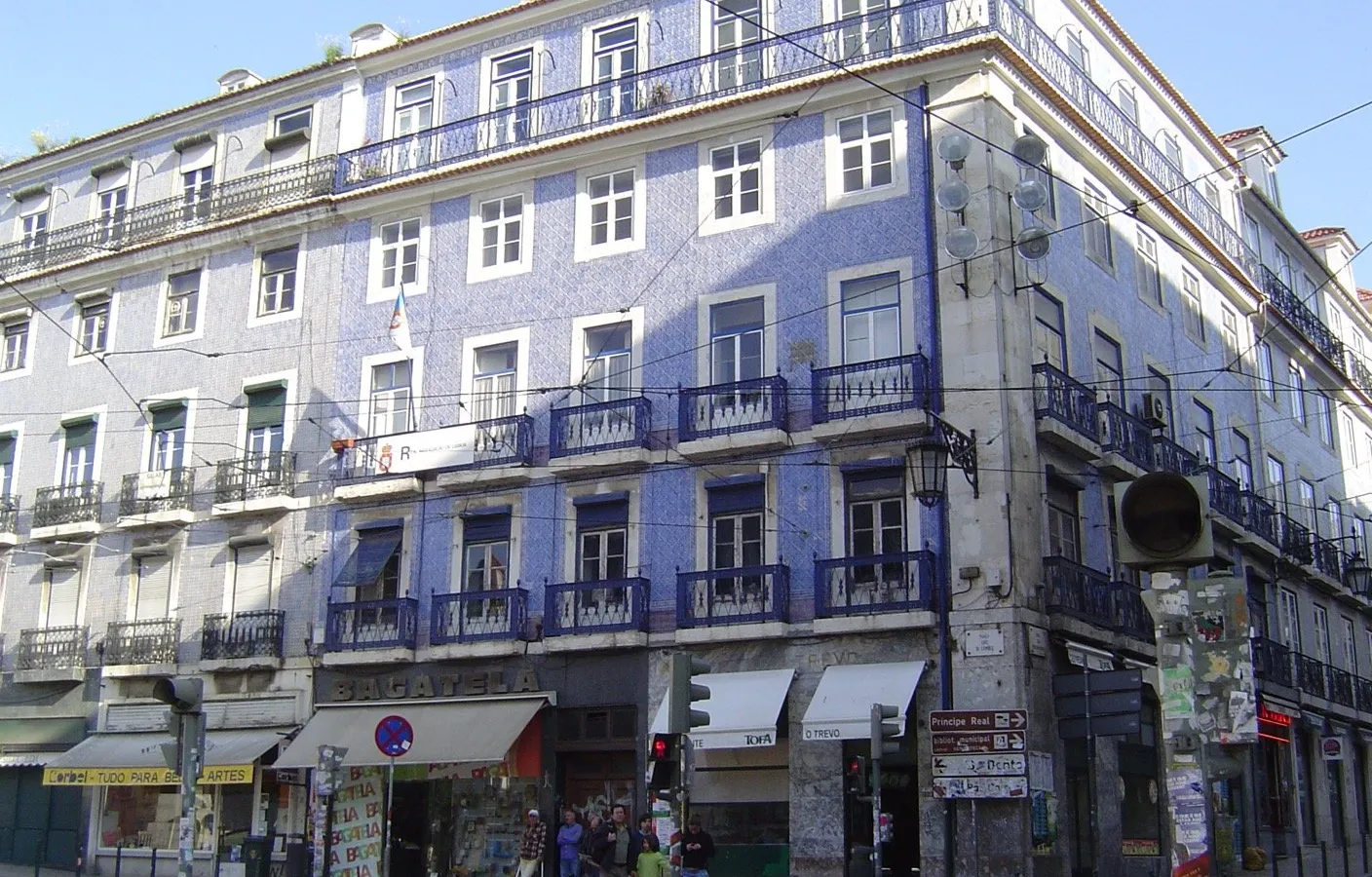 Tiled Lisbon apartment building with iron balconies, renting vs buying in Portugal