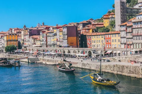 Porto Ribeira riverfront with colorful houses and rabelo boats on the Douro, illustrating the cost of living in Porto Portugal 2026