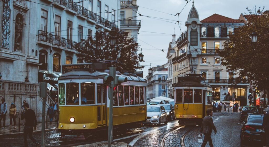 Lisbon yellow trams on cobblestone street — moving to Portugal from the USA