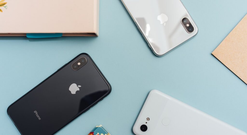 iPhones and Pixel smartphones on blue background representing Portugal SIM card options for US travelers