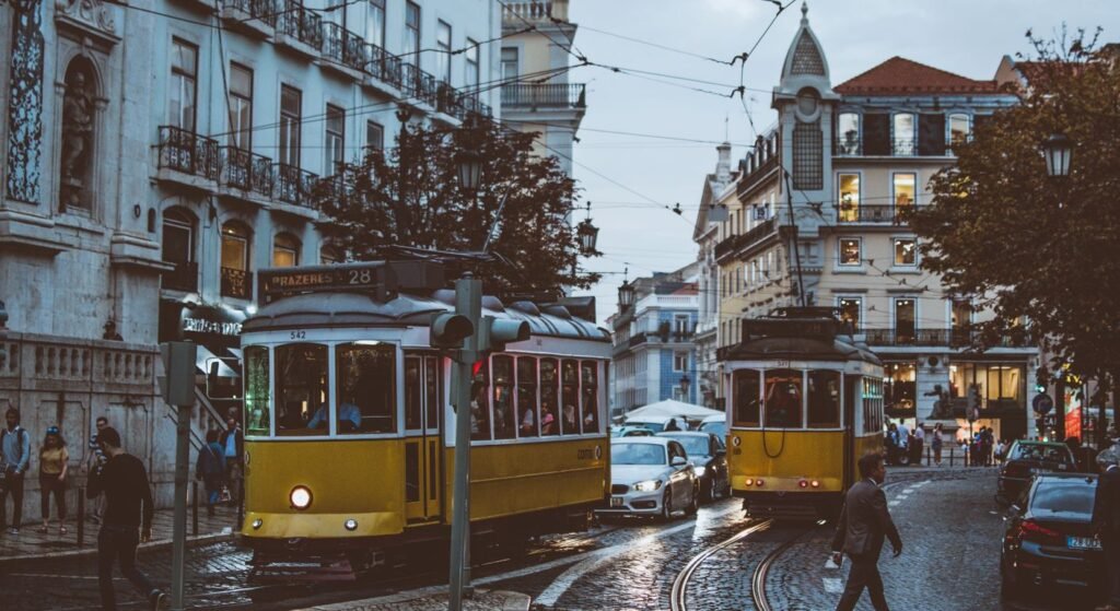 Yellow trams on a Lisbon street, one of the best places to live in Portugal for expats