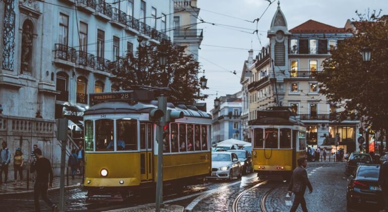 Yellow trams on a Lisbon street, one of the best places to live in Portugal for expats