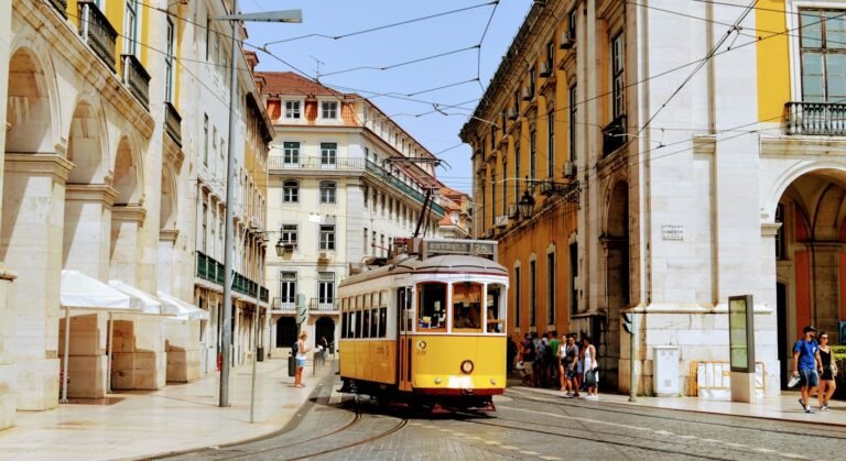 Historic yellow tram in central Lisbon — best cities for Americans in Portugal