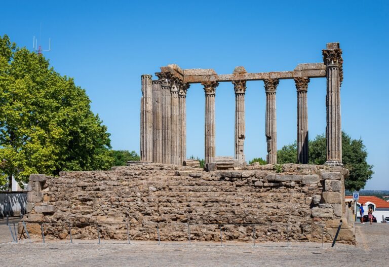 Roman temple of Evora with Corinthian columns under blue sky, Alentejo Portugal travel guide